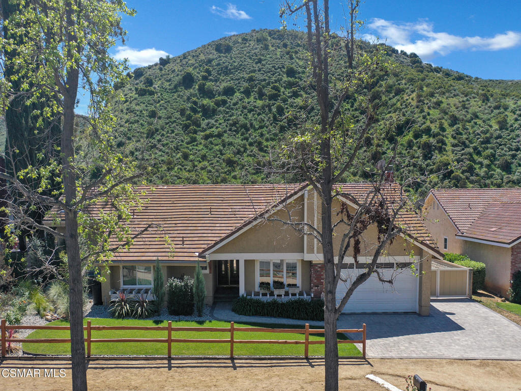 1590 Meander Drive Simi Valley, CA 93065 - Photo 49 of 57 a view of a white house next to a yard with large trees