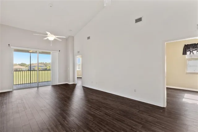a living room with furniture and a floor to ceiling window