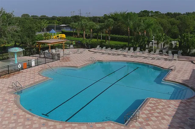 an aerial view of a house with a yard basket ball court and outdoor seating