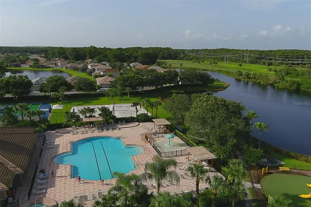an aerial view of residential houses with outdoor space and river