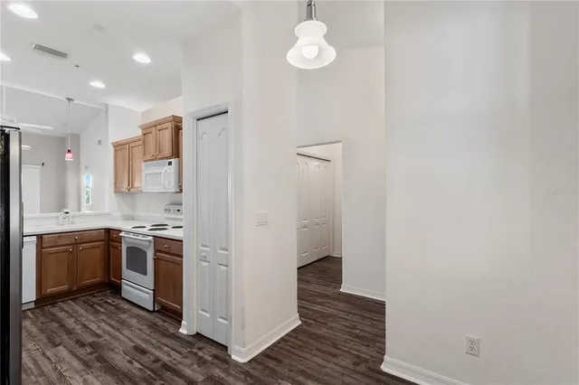 a kitchen with a sink a refrigerator and cabinets