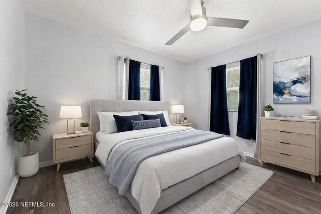 a bedroom with a bed and a potted plant