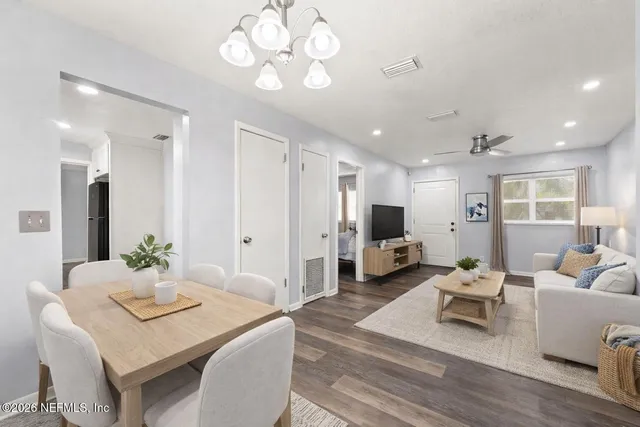a living room with furniture and a chandelier