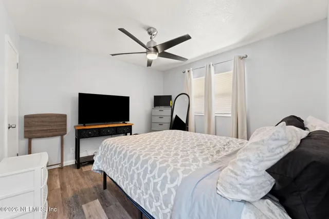 a bedroom with a bed and a flat screen tv