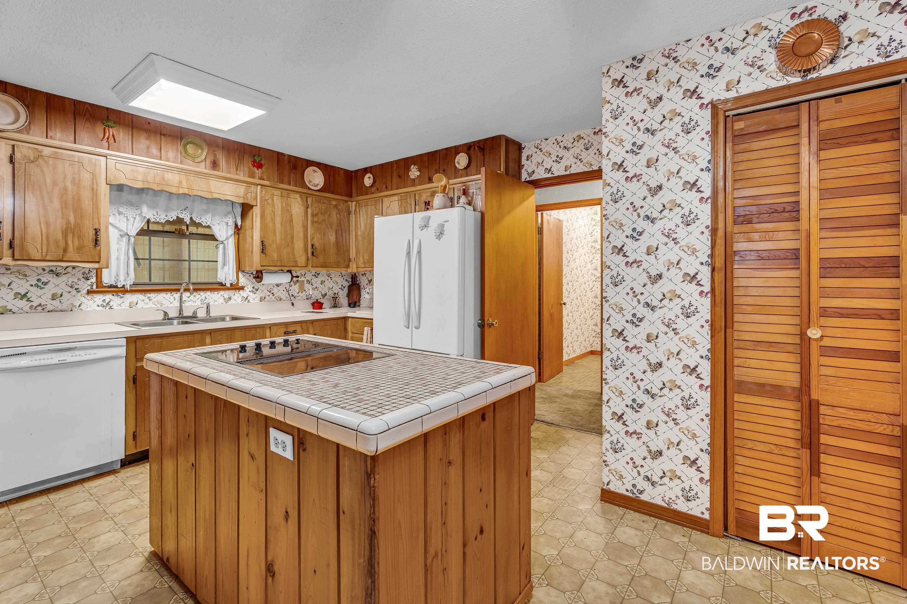 72075 Highway 59 Little River, AL 36550 - Photo 10 of 40 Kitchen featuring wallpapered walls, white appliances, light floors, brown cabinets, and tile counters