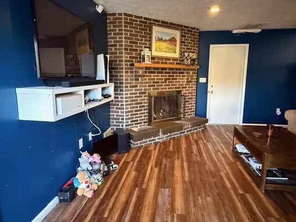 a living room with furniture fireplace and flat screen tv