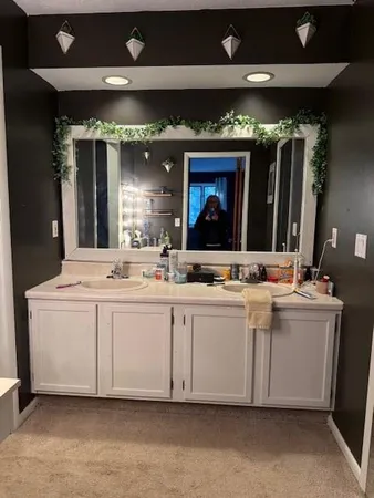 a bathroom with a sink vanity and mirror
