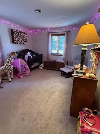 a bed sitting in a bedroom next to a window