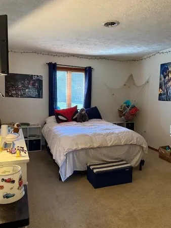 a bed room with a bed and a large mirror