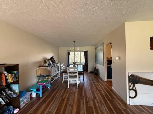 a view of a livingroom with furniture hardwood floor and a ceiling fan