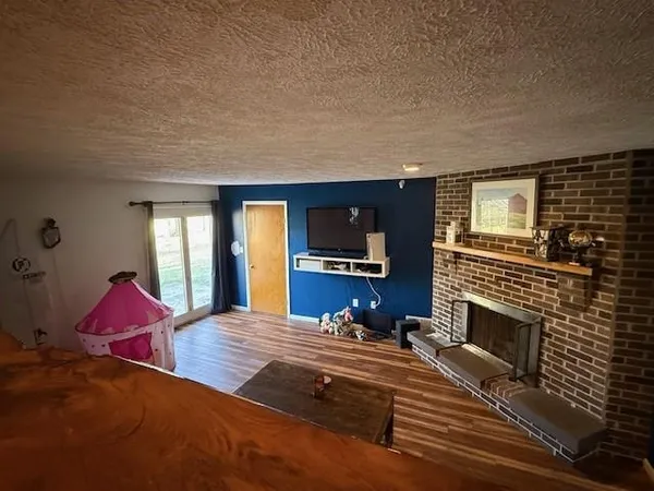 a living room with furniture a flat screen tv and a fireplace