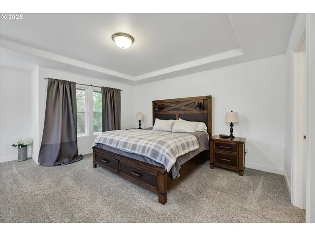 a bed sitting in a bedroom next to a window