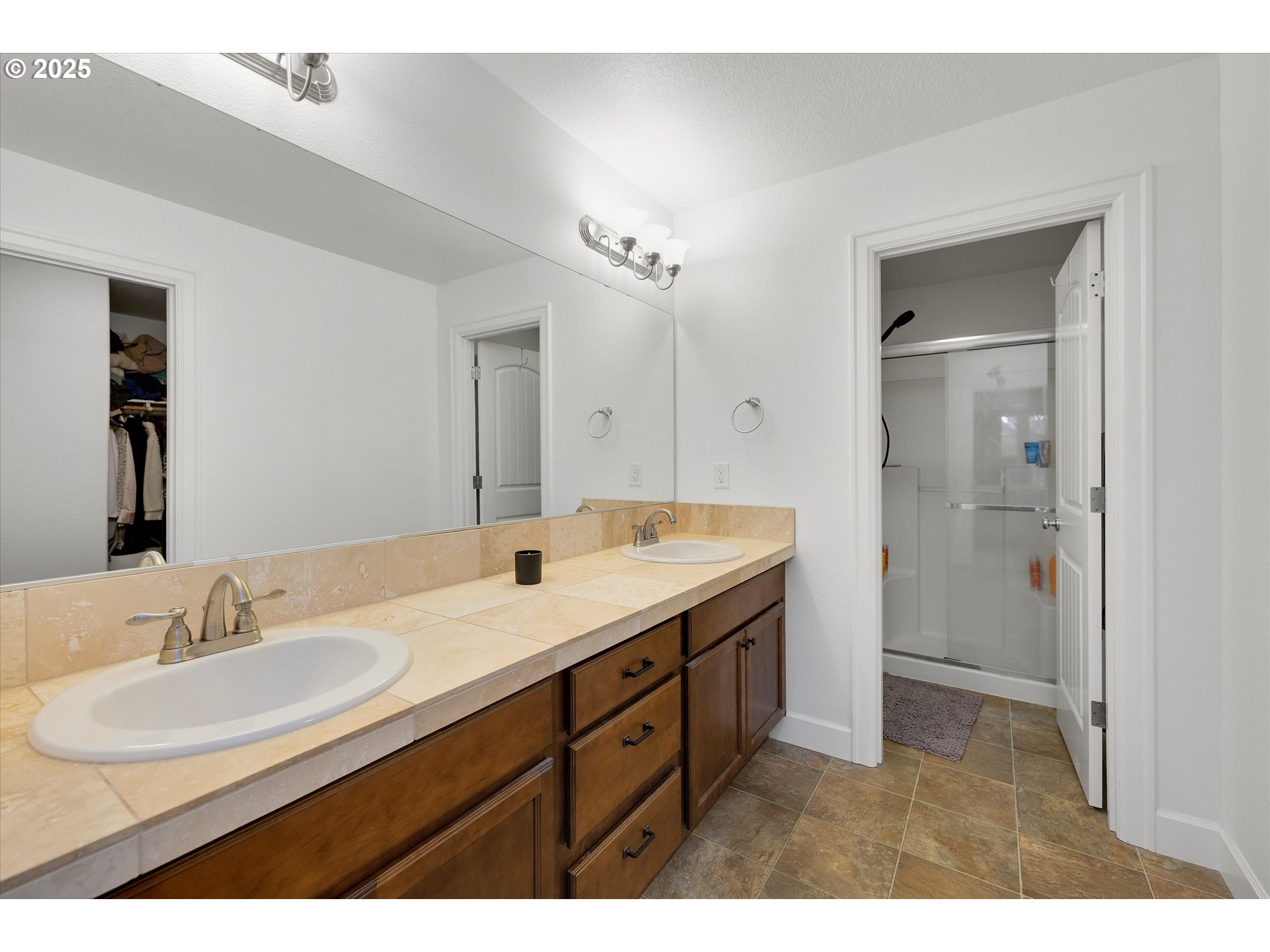 19003 Southeast Village Boulevard Sandy, OR 97055 - Photo 20 of 34 a bathroom with a sink double vanity granite tub and a mirror