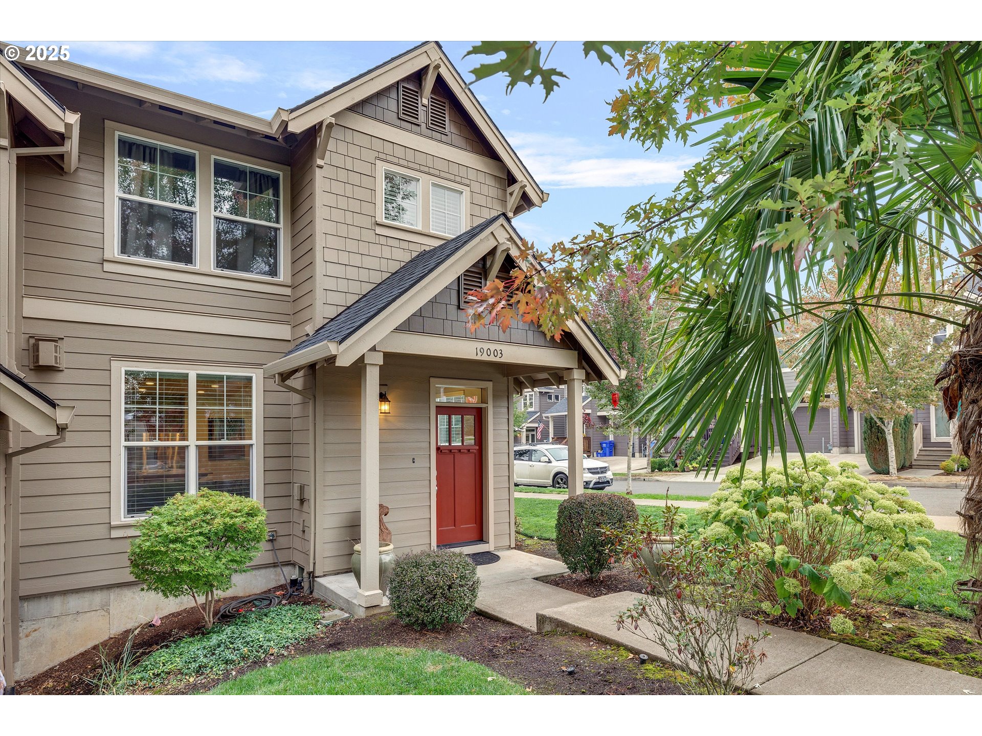 19003 Southeast Village Boulevard Sandy, OR 97055 - Photo 2 of 34 a view of a house with a yard and potted plants
