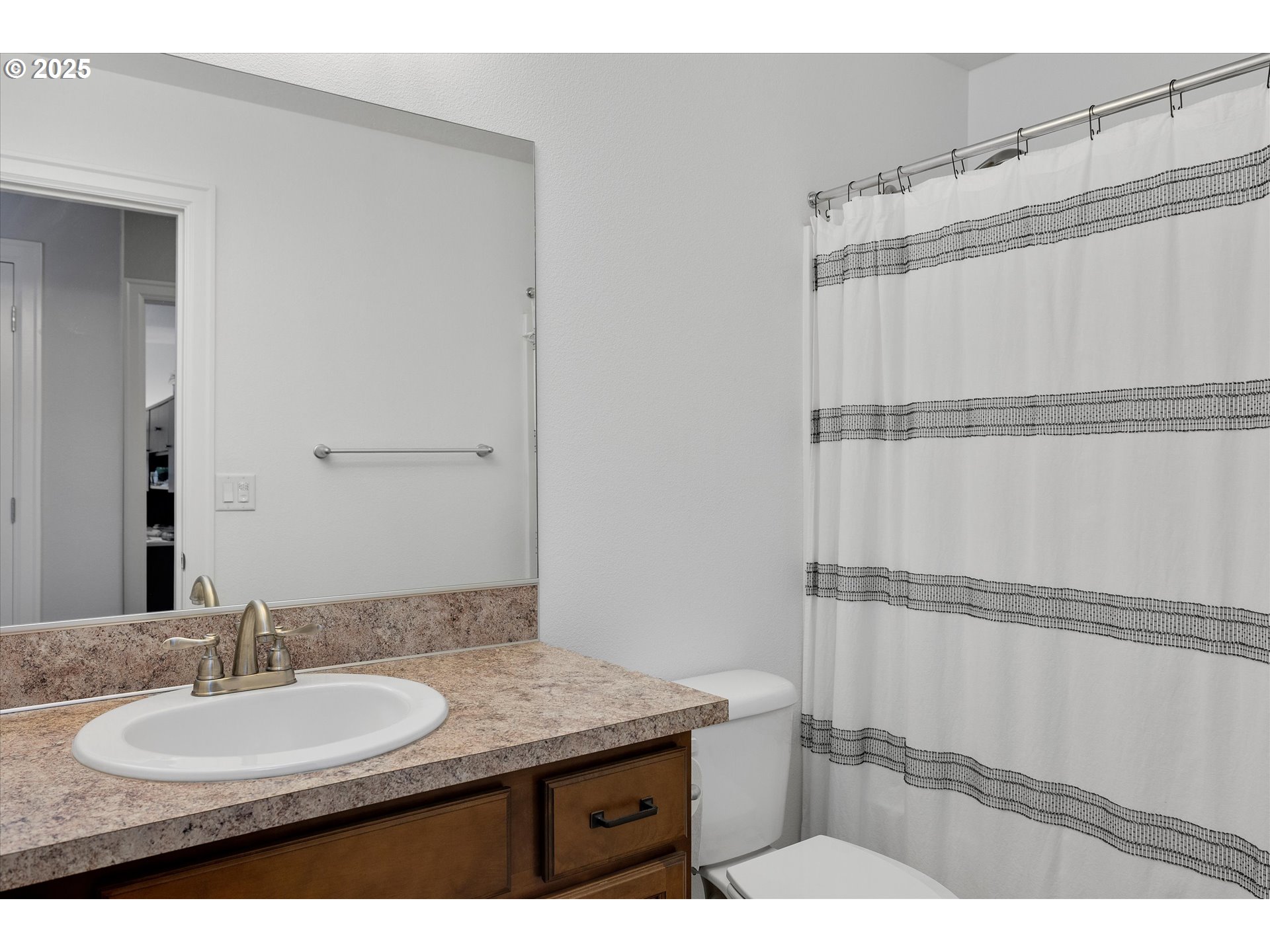 19003 Southeast Village Boulevard Sandy, OR 97055 - Photo 22 of 34 a bathroom with a granite countertop sink and a mirror