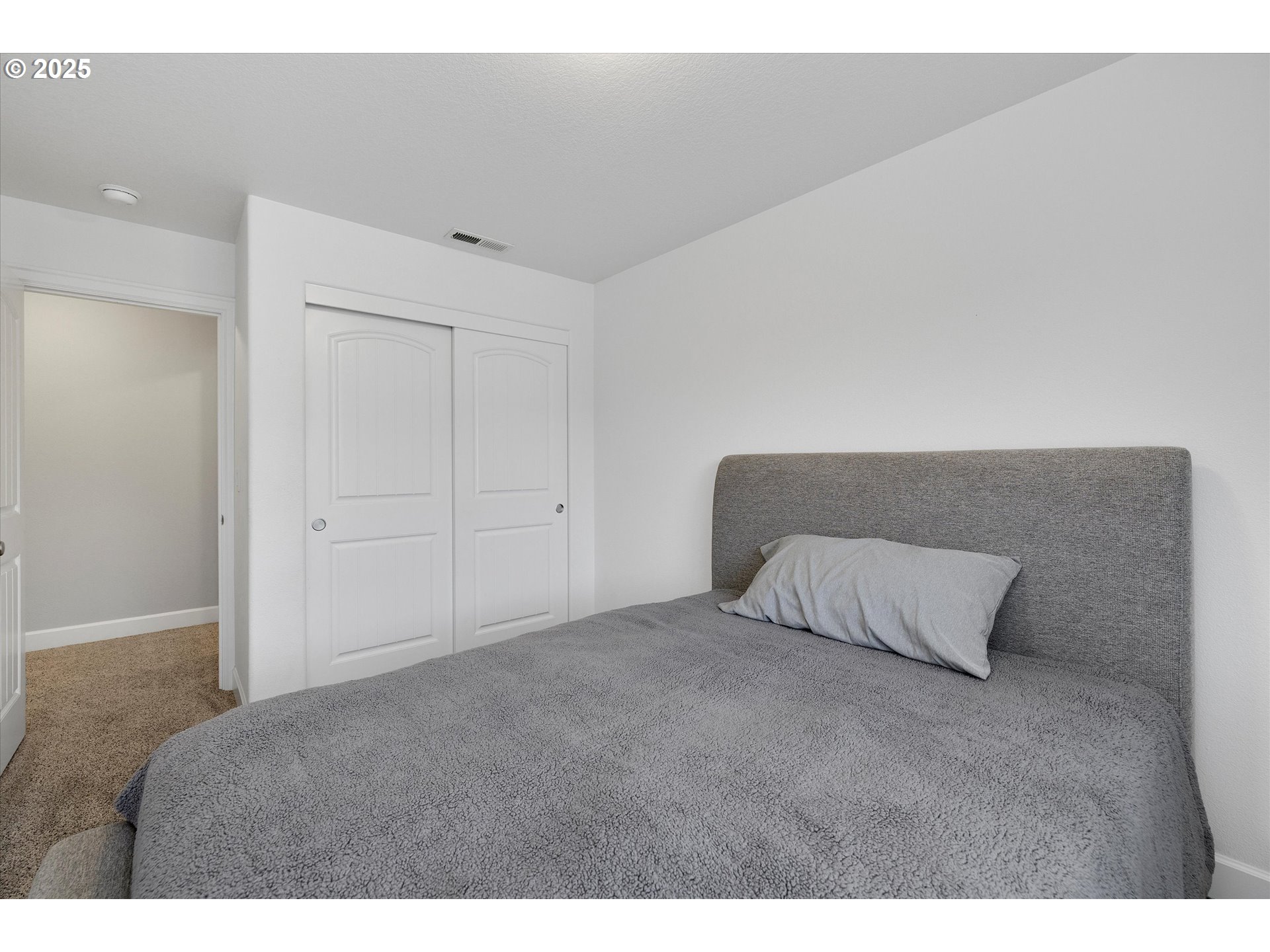 19003 Southeast Village Boulevard Sandy, OR 97055 - Photo 26 of 34 a room with a bed and a night stand