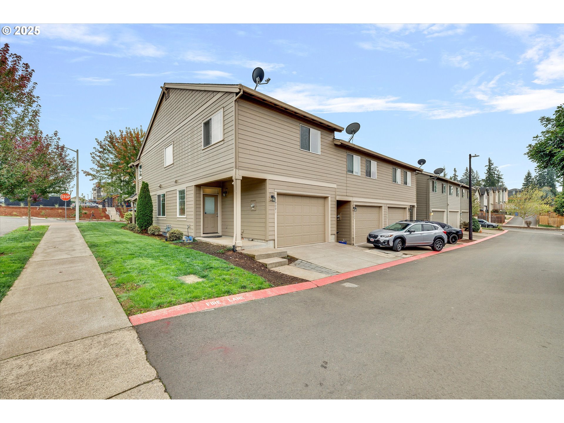 19003 Southeast Village Boulevard Sandy, OR 97055 - Photo 28 of 34 a front view of a house with a yard and garage