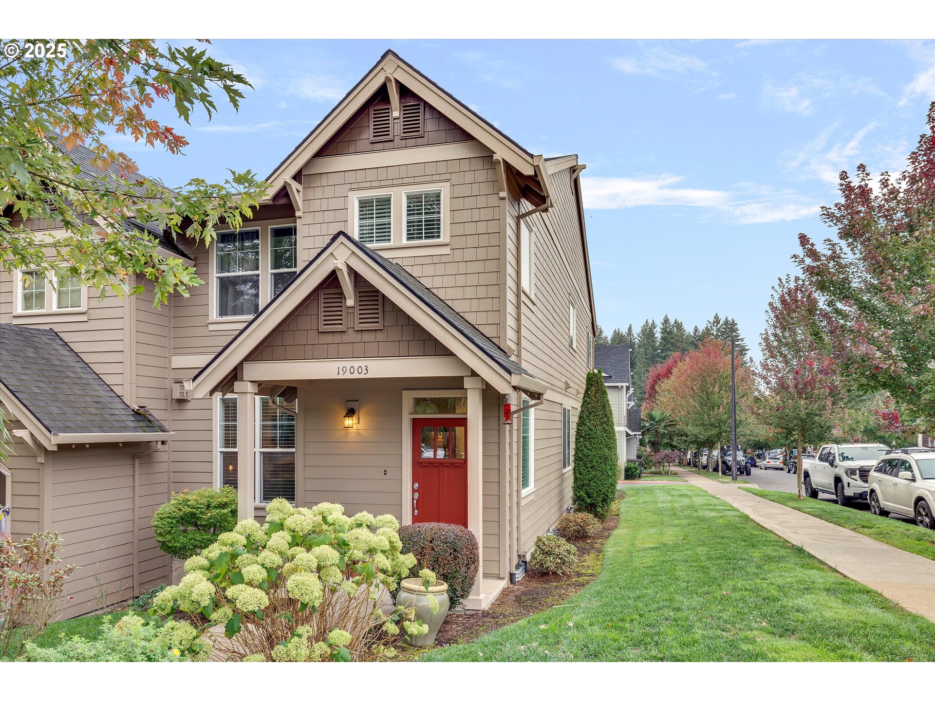 19003 Southeast Village Boulevard Sandy, OR 97055 - Photo 30 of 34 a front view of a house with a yard and garage