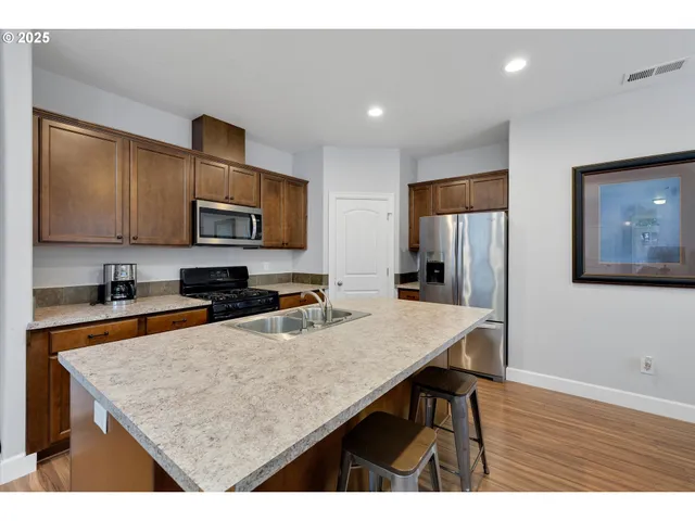 a kitchen with refrigerator cabinets and wooden floor