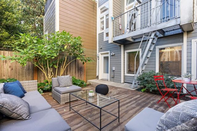 a view of a patio with couches and potted plants