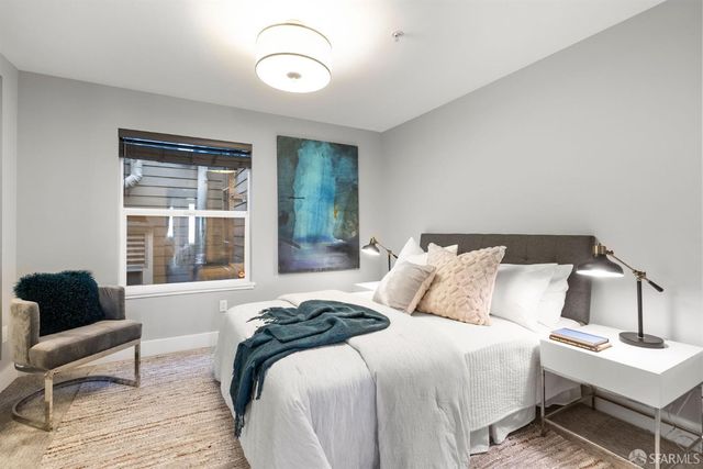 a bedroom with bed and a window