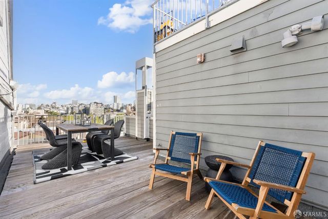 a view of a terrace with wooden floor and outdoor seating