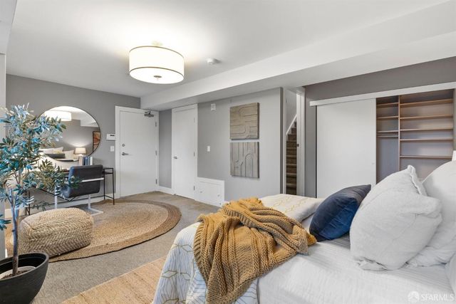 a bedroom with a bed and a chandelier