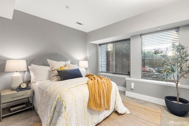 a bed sitting in a bedroom next to a window