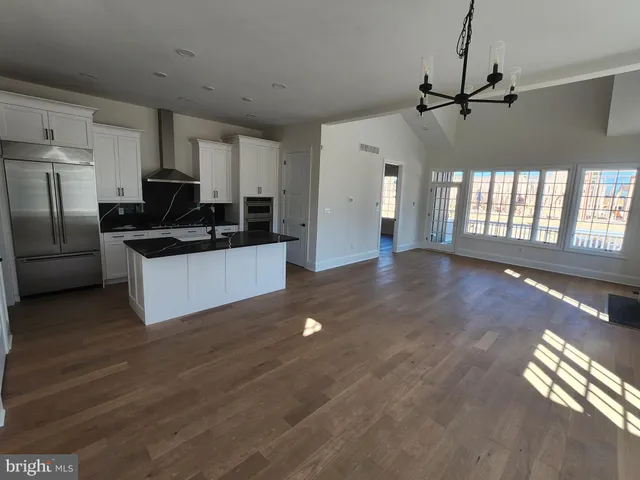 a kitchen with granite countertop a stove and a refrigerator