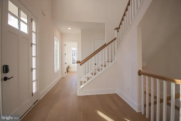 a view of a hallway with wooden floor and entryway