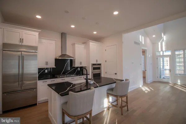 a kitchen with kitchen island a appliances dining table and chairs