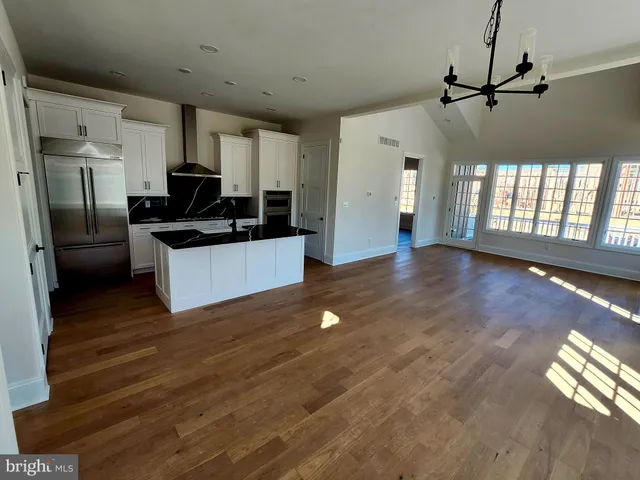a kitchen with granite countertop a stove and a refrigerator