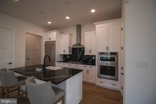 a kitchen with a sink cabinets and stainless steel appliances