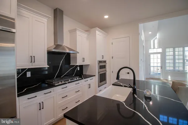 a kitchen with a sink a counter and cabinets