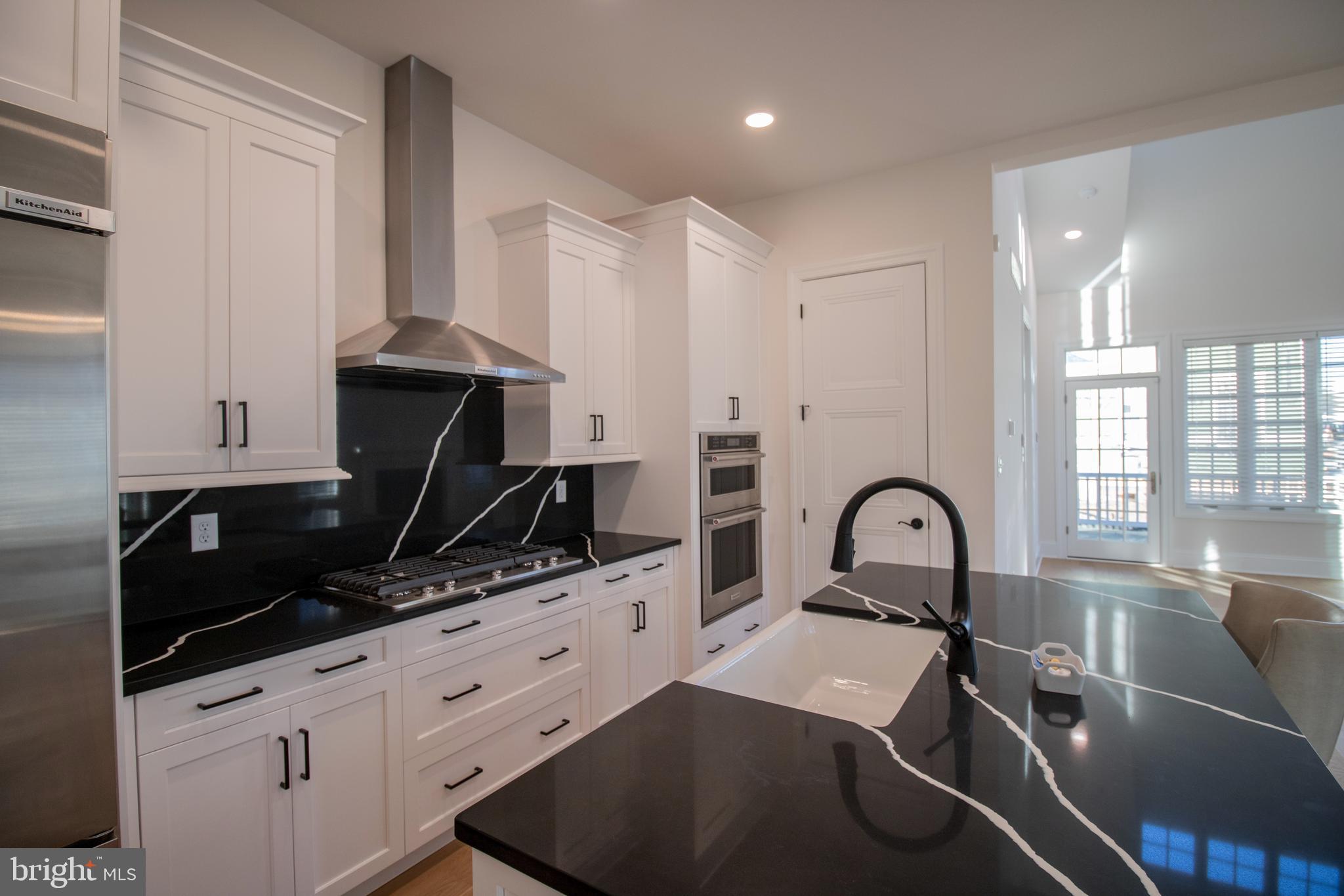 1115 Invermere Road Wilmington, DE 19803 - Photo 9 of 16 a kitchen with a sink a counter and cabinets