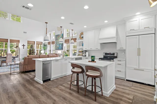 a kitchen with white cabinets and white appliances