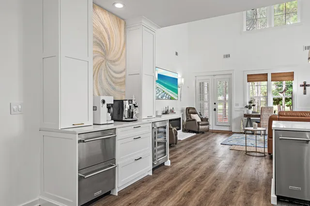 a kitchen with white cabinets and appliances