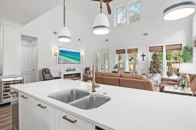 a kitchen with a sink a counter top space and a chandelier