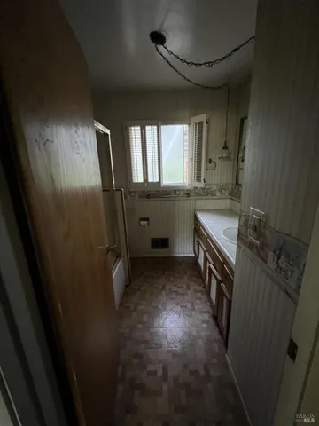 a bathroom with double vanity and a window