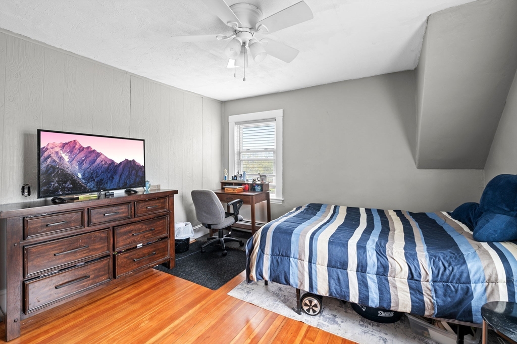 42 Chase Street Danvers, MA 01923 - Photo 18 of 37 a bedroom with a bed and glass wall