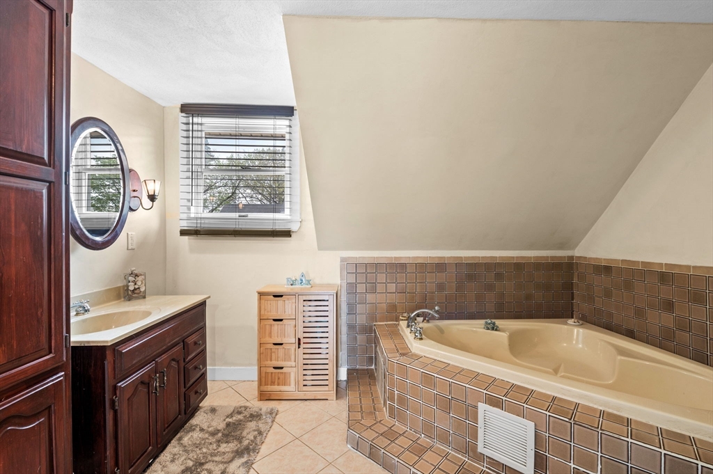 42 Chase Street Danvers, MA 01923 - Photo 20 of 37 a bathroom with a bathtub sink and mirror
