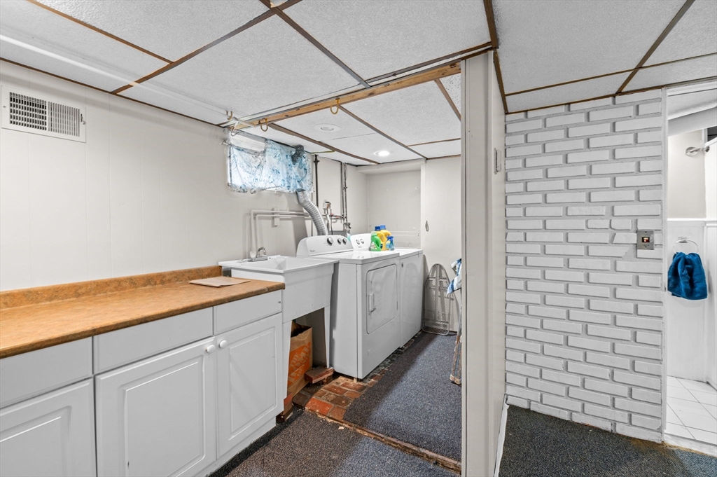 42 Chase Street Danvers, MA 01923 - Photo 24 of 37 a utility room with cabinets