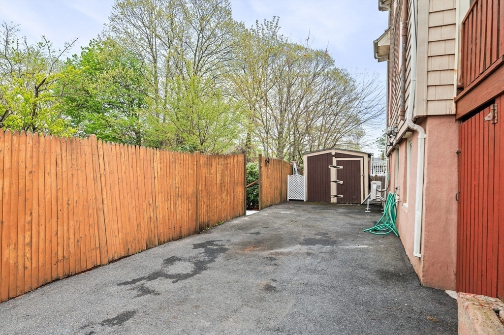 42 Chase Street Danvers, MA 01923 - Photo 29 of 37 a view of a house with a garage and trees