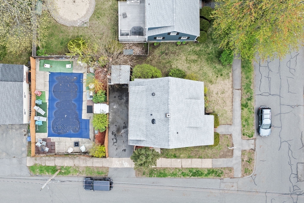 42 Chase Street Danvers, MA 01923 - Photo 33 of 37 an aerial view of a house with a yard and a sitting area