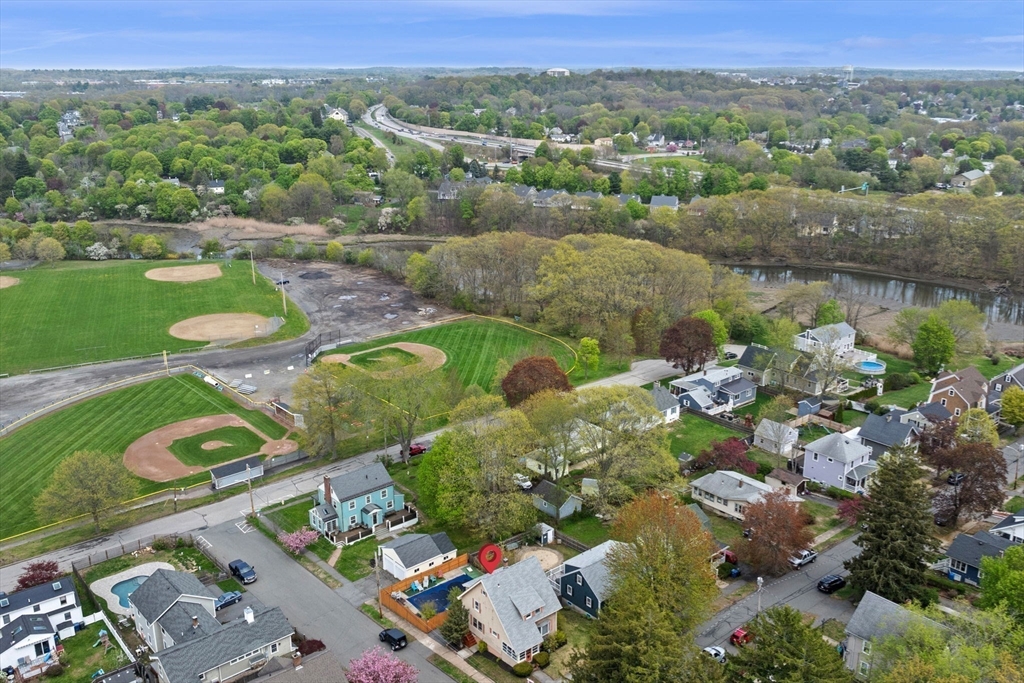 42 Chase Street Danvers, MA 01923 - Photo 34 of 37 an aerial view of green landscape with trees houses and lake view