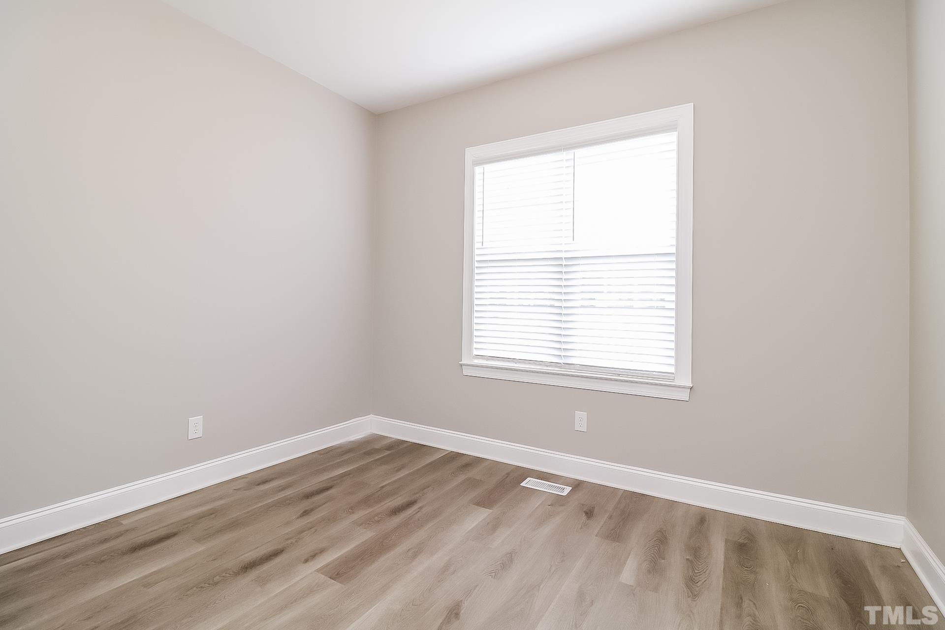 98 Moonlight Drive Garner, NC 27529 - Photo 13 of 17 an empty room with a window