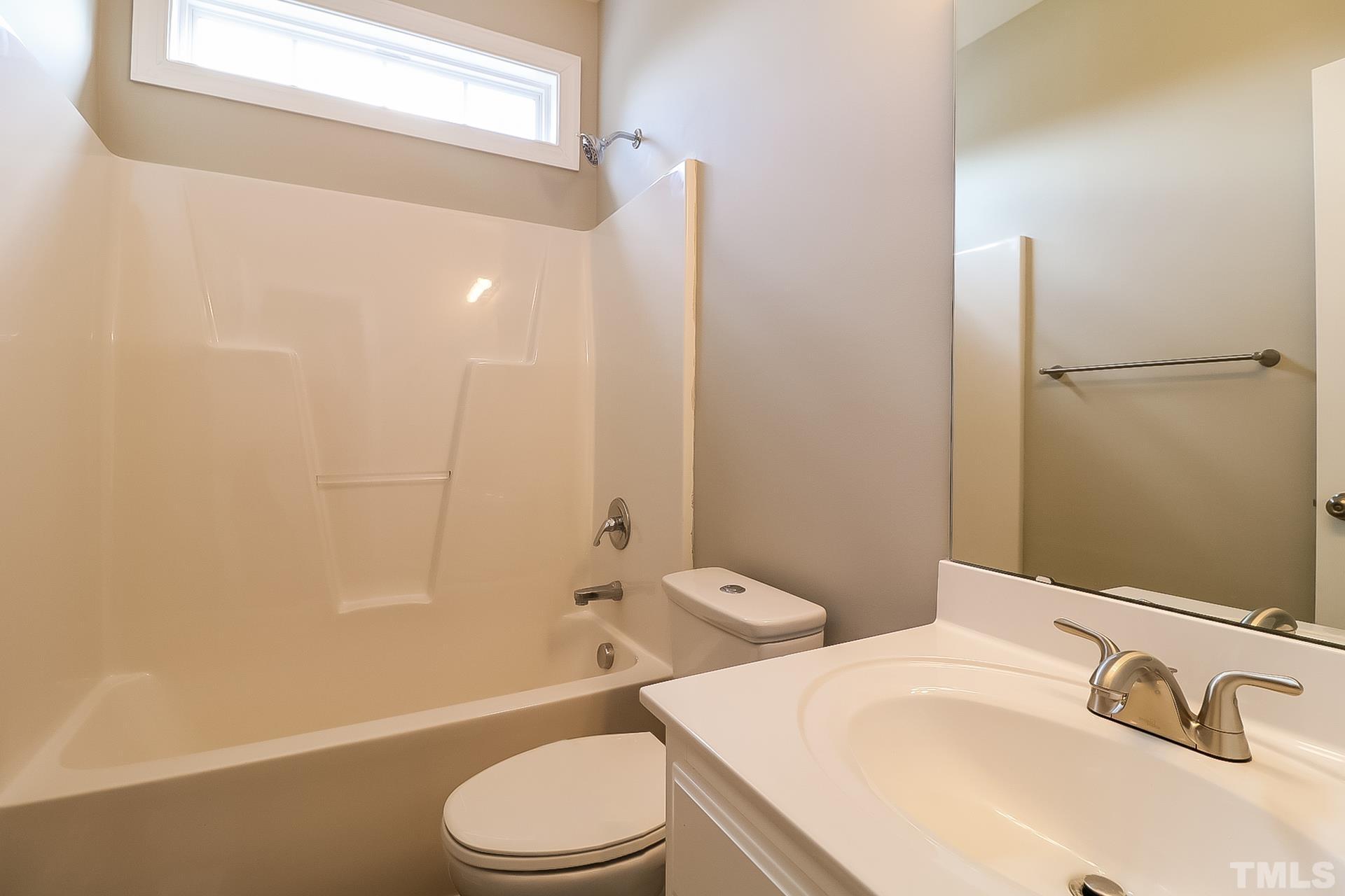 98 Moonlight Drive Garner, NC 27529 - Photo 15 of 17 a bathroom with a sink a toilet and shower
