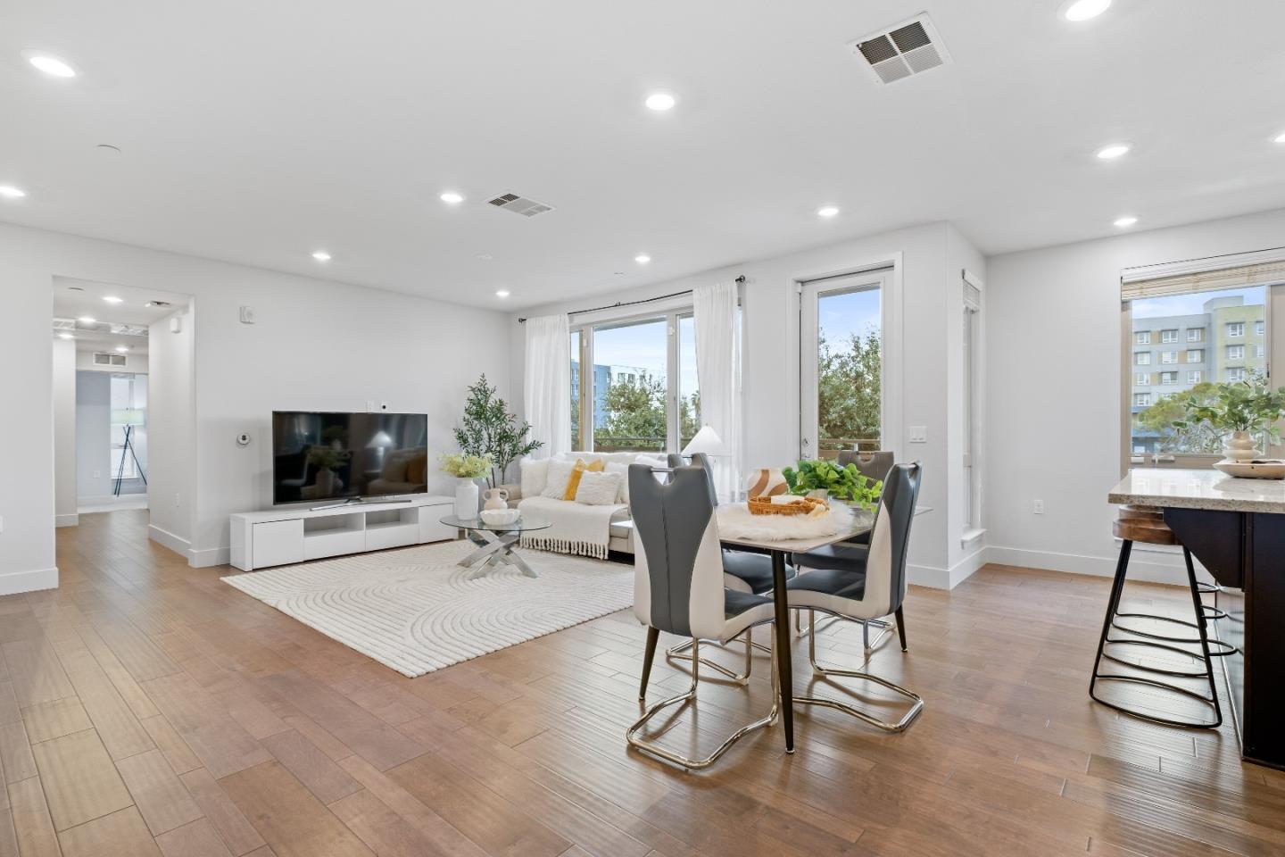 330 Riesling Avenue, Unit 23 Milpitas, CA 95035 - Photo 12 of 51 a living room with furniture a flat screen tv and a large window