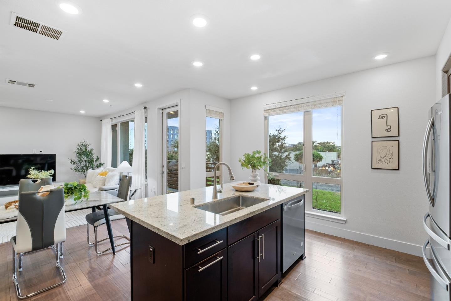 330 Riesling Avenue, Unit 23 Milpitas, CA 95035 - Photo 16 of 51 a kitchen with a table chairs and wooden floor