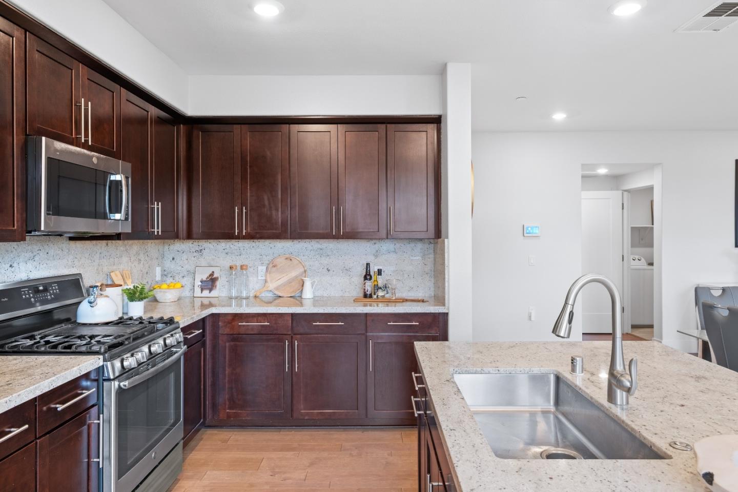 330 Riesling Avenue, Unit 23 Milpitas, CA 95035 - Photo 20 of 51 a kitchen with a sink and a stove top oven
